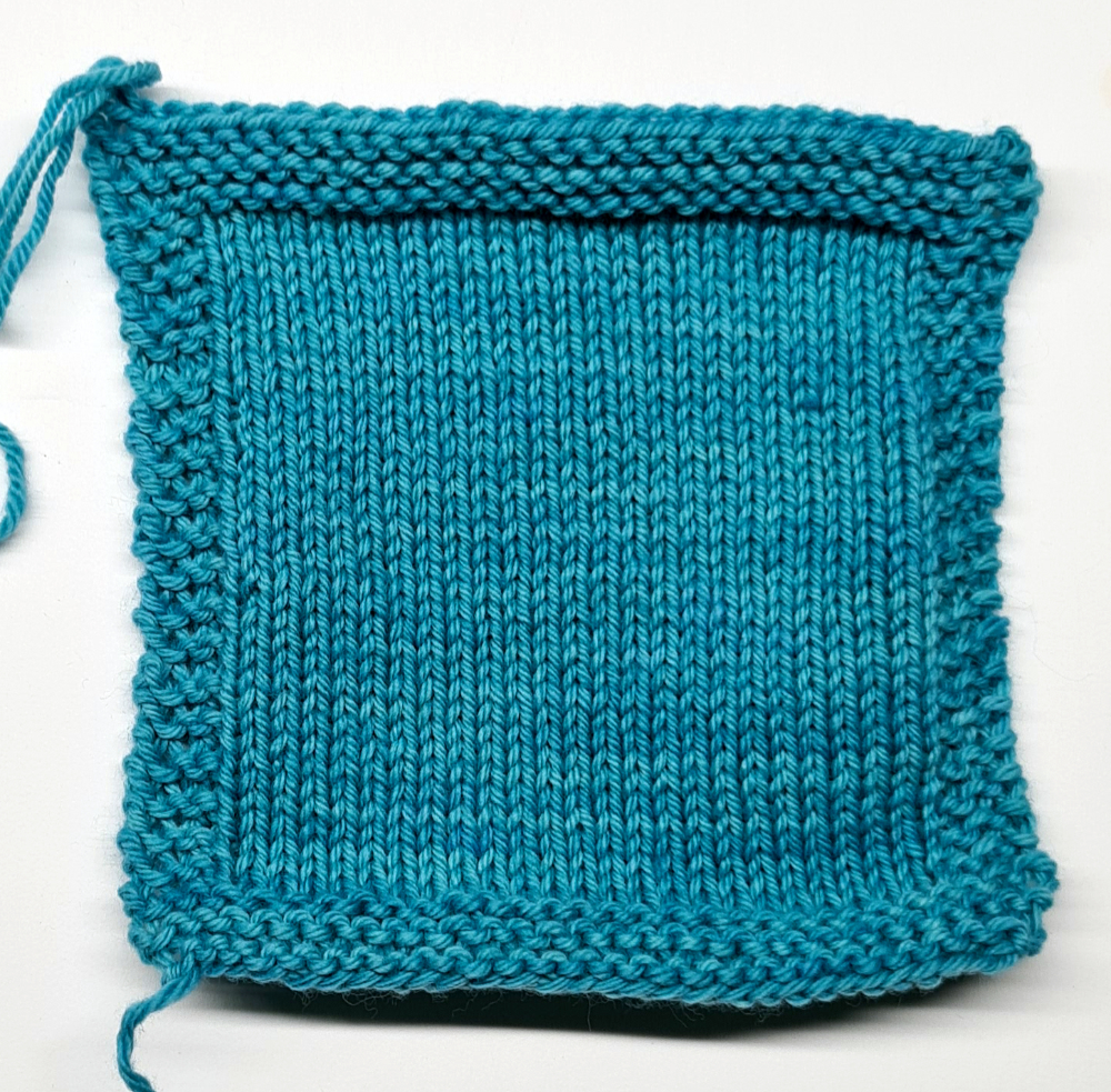 knitted swatch in turquoise, edges lie flat